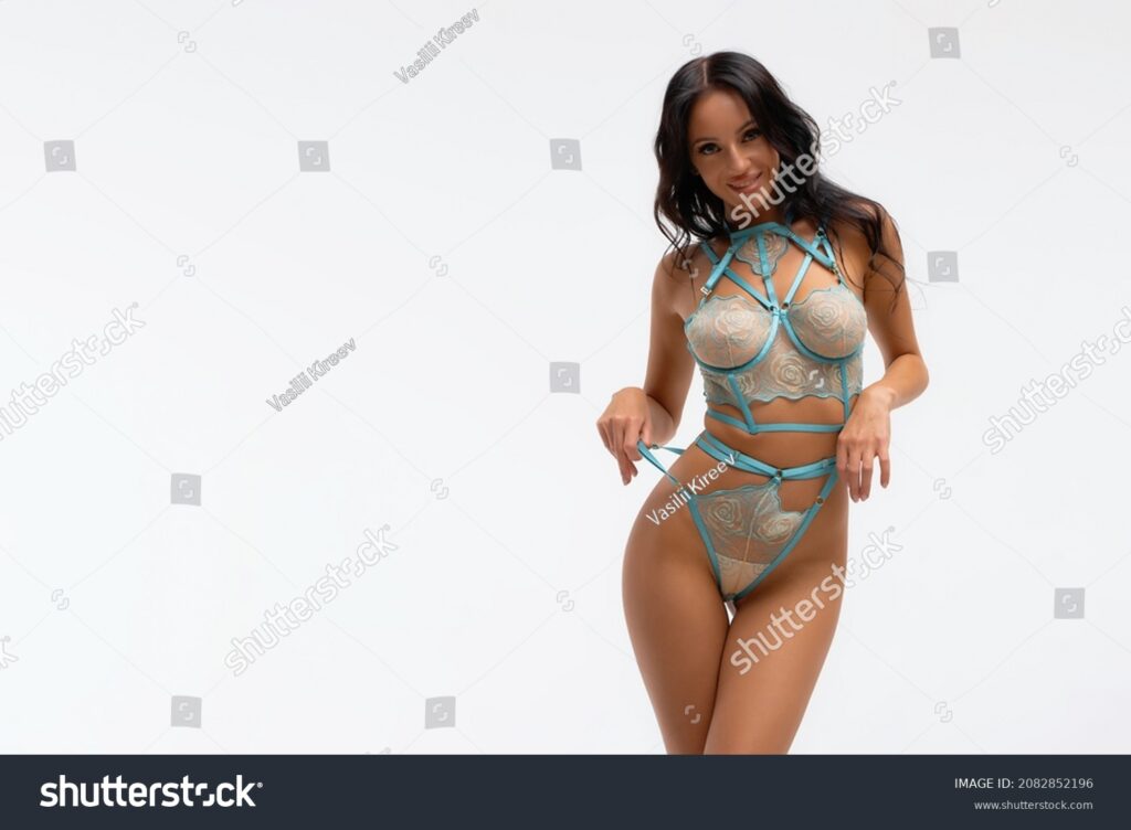 stock photo sexy female in blue underwear and harness standing on white background and looking at camera 2082852196 stock photo sexy female in blue underwear and harness standing on white background and looking at camera 2082852196
